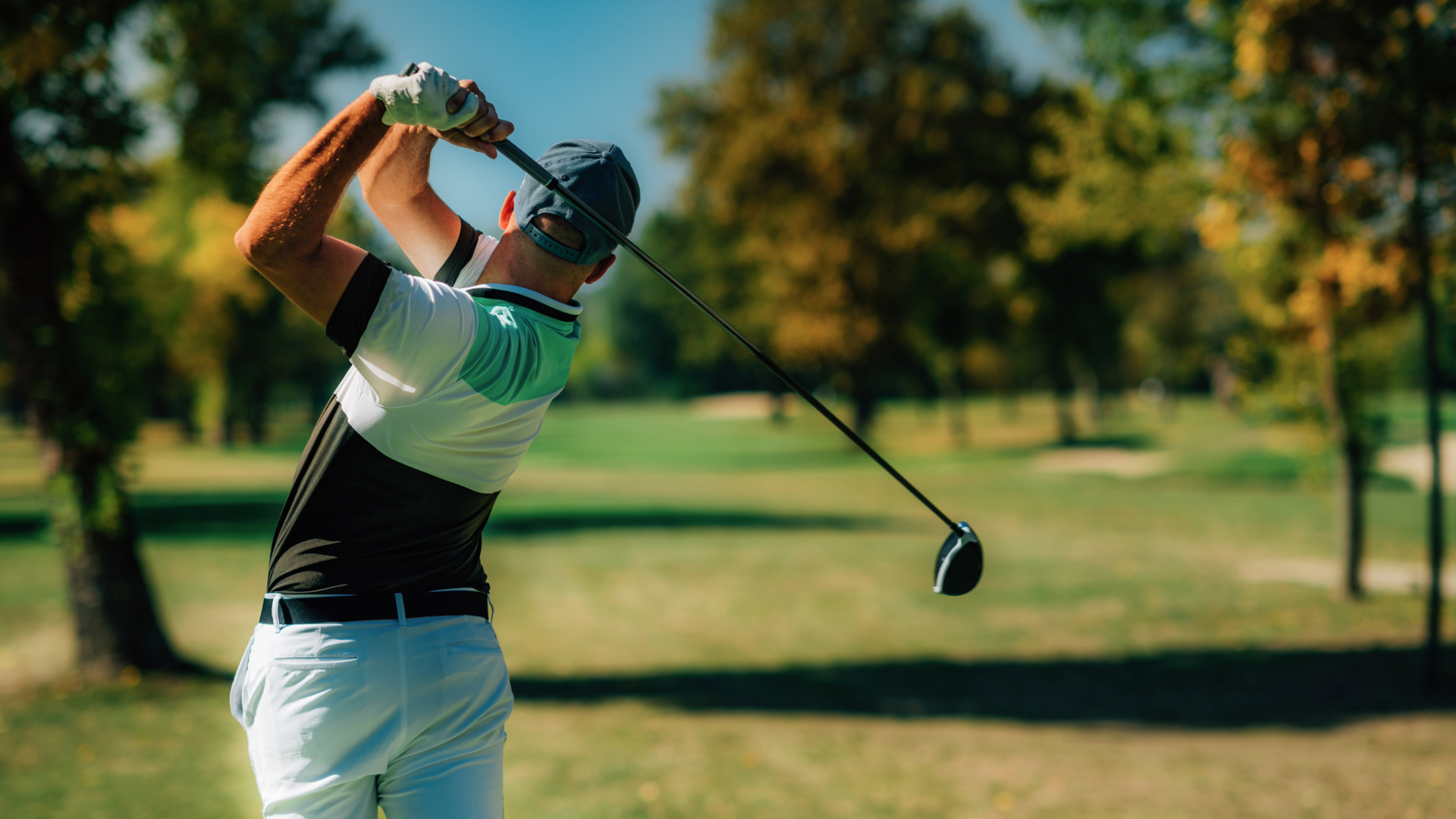 Golfer with club behind his back after a swing